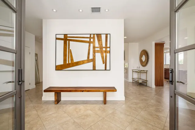 a living room with furniture a large window and a flat screen tv
