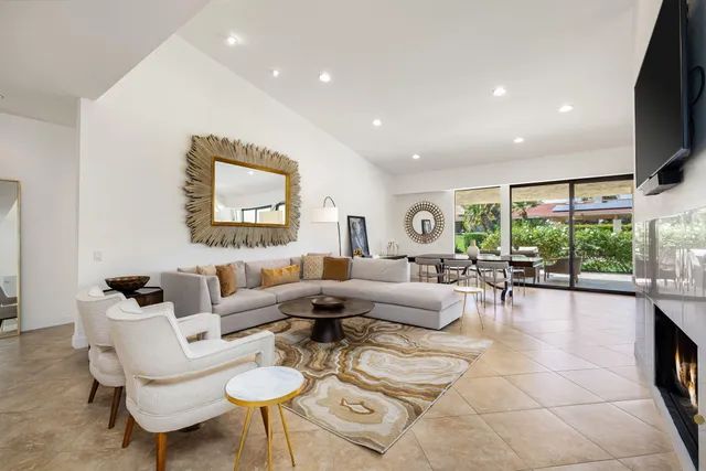 a bathroom with a granite countertop sink and a large mirror