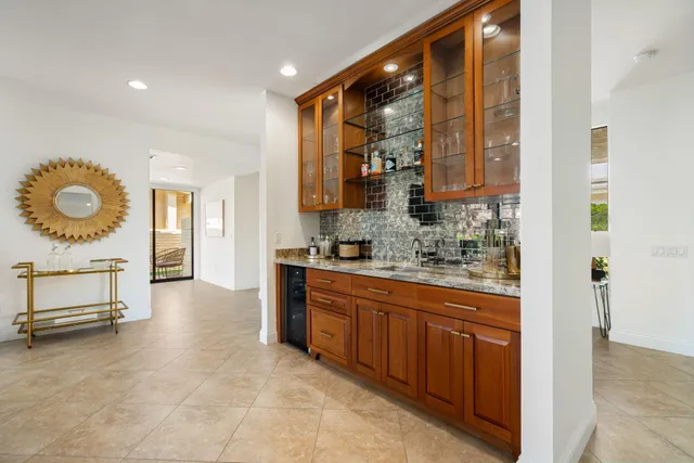 a kitchen with stainless steel appliances granite countertop a sink counter space and a stove top oven