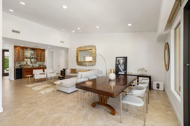 a spacious bathroom with a granite countertop sink a mirror and a shower