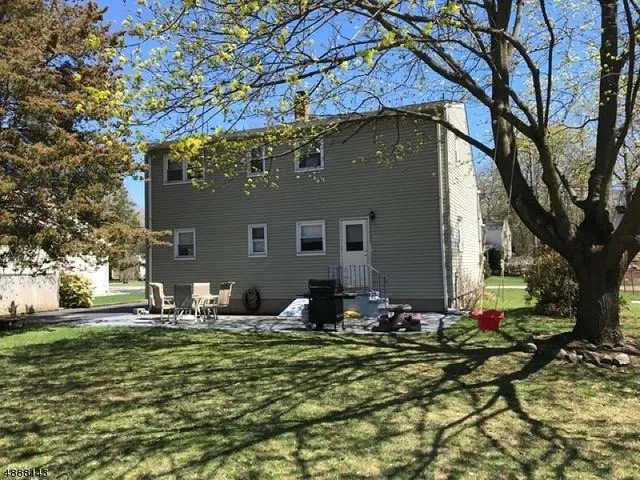 a backyard of a house with table and chairs