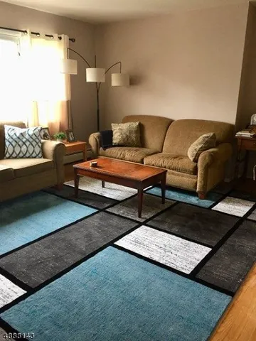 a living room with furniture and a rug