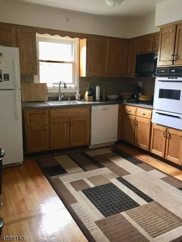 a kitchen with a sink cabinets and window