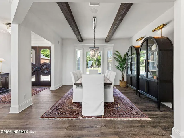a living room with furniture and a large window with outer view
