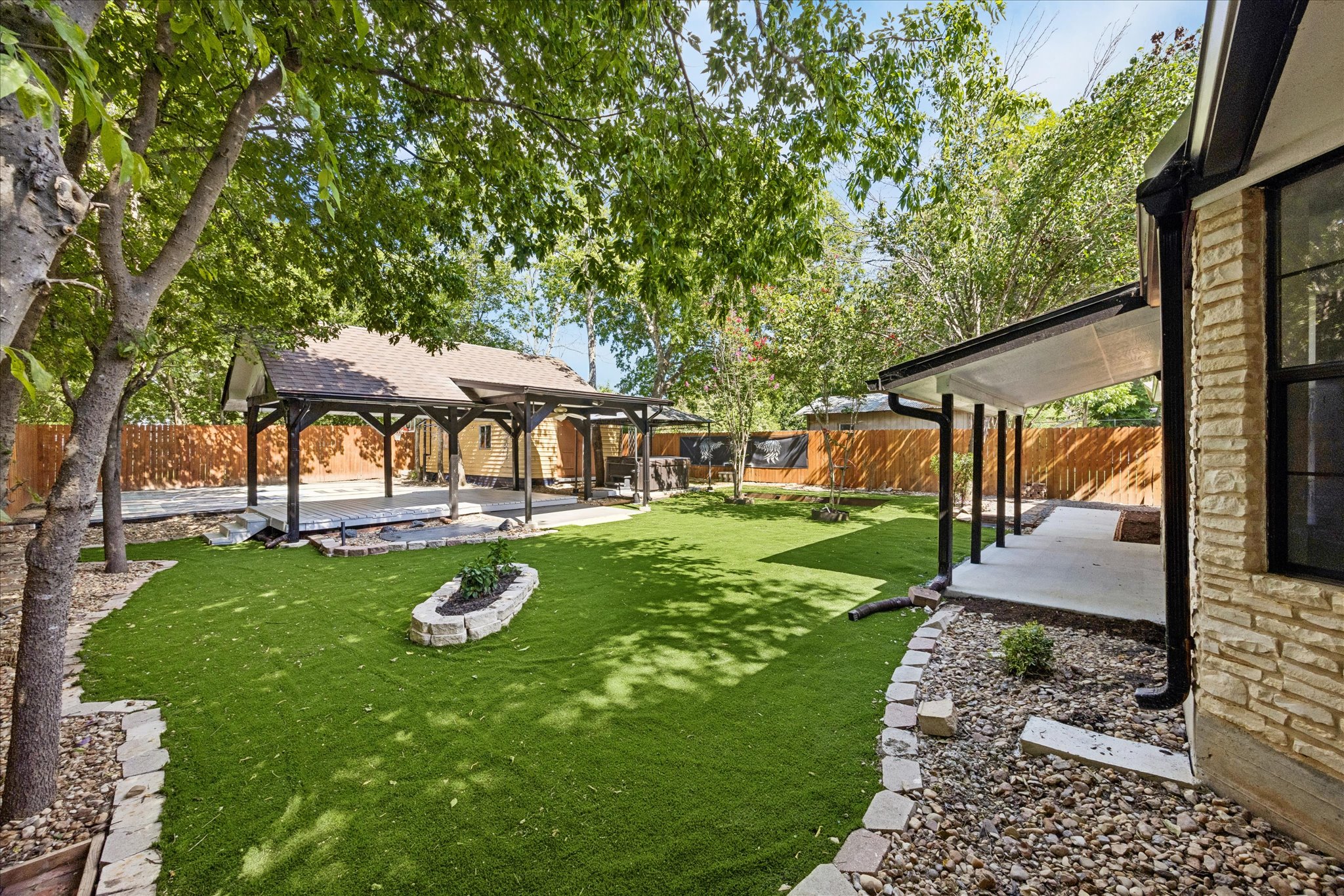1706 Davis Street Taylor, TX 76574 - Photo 14 of 18 A private yard with artificial turf and a covered patio offers ideal outdoor entertaining.