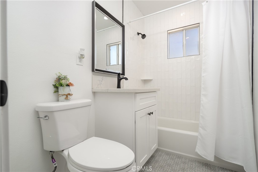38859 Mesquite Road Palmdale, CA 93551 - Photo 17 of 36 a white toilet sitting next to a bathroom sink and tub