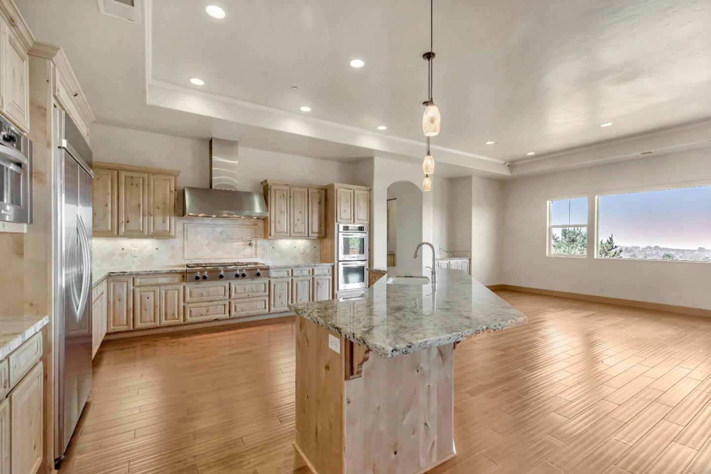 8944 Hidden Canyon Road Salinas, CA 93907 - Photo 12 of 22 a large kitchen with kitchen island a large island a sink stainless steel appliances and cabinets