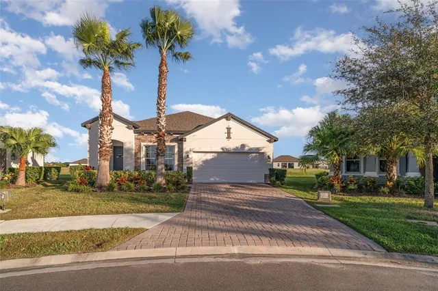 a front view of a house with a yard and trees