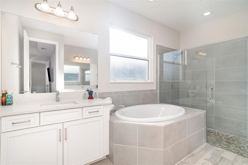 1904 146th Terrace East Parrish, FL 34219 - Photo 13 of 40 a bathroom with a sink a toilet a mirror and shower