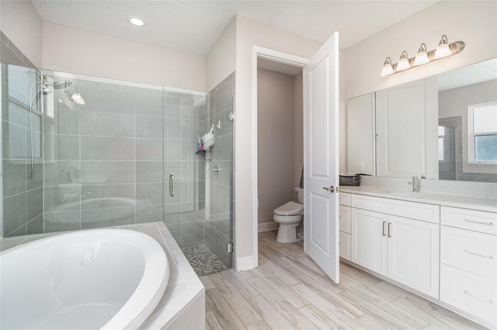 1904 146th Terrace East Parrish, FL 34219 - Photo 14 of 40 a bathroom with a bathtub and a toilet