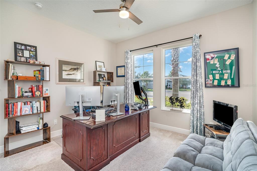1904 146th Terrace East Parrish, FL 34219 - Photo 17 of 40 a living room with furniture a flat screen tv and a large window