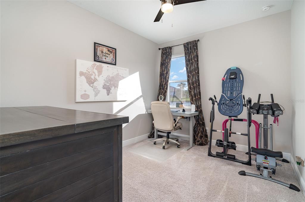 1904 146th Terrace East Parrish, FL 34219 - Photo 19 of 40 a view of a workspace with furniture and a window