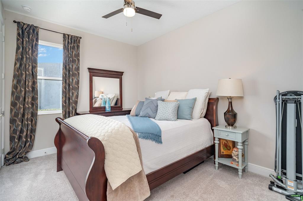 1904 146th Terrace East Parrish, FL 34219 - Photo 6 of 40 a bedroom with a bed and a chandelier