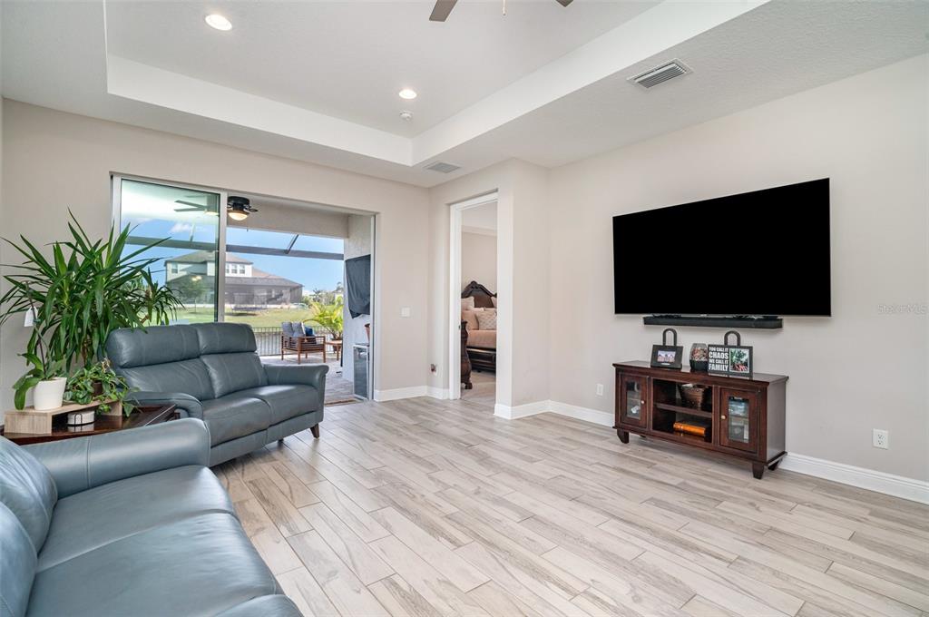 1904 146th Terrace East Parrish, FL 34219 - Photo 8 of 40 a living room with furniture and a flat screen tv