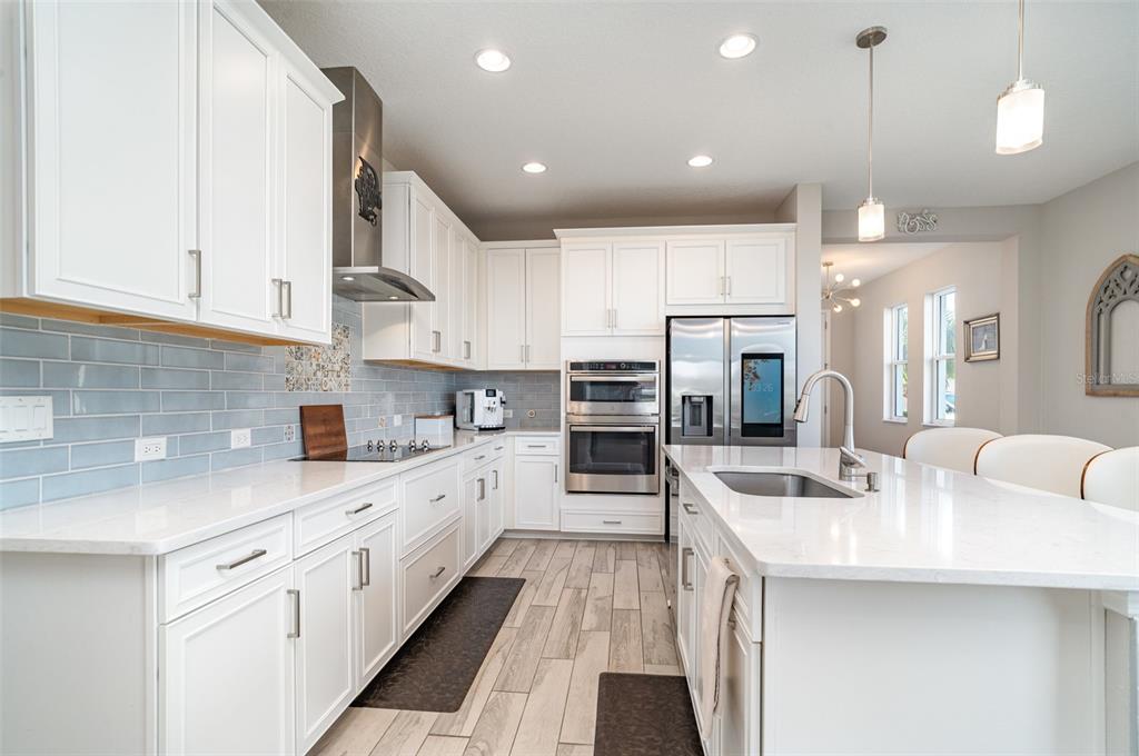 1904 146th Terrace East Parrish, FL 34219 - Photo 10 of 40 a large white kitchen with lots of counter space a sink and cabinets