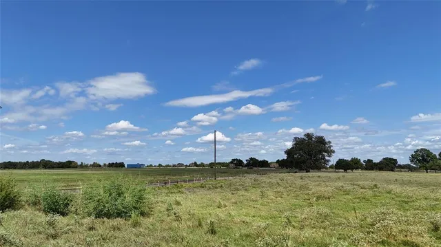 a view of field with ocean in background