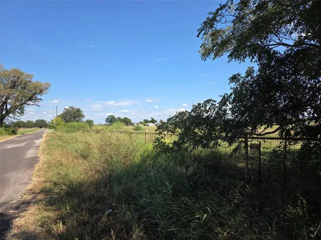 a view of a lake with houses in back