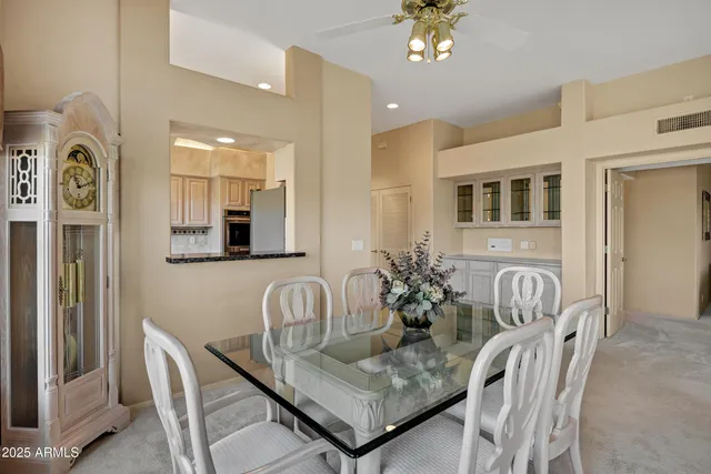 a dining room with furniture and chandelier