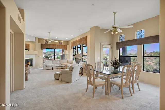 a view of a dining room and livingroom with furniture wooden floor a chandelier