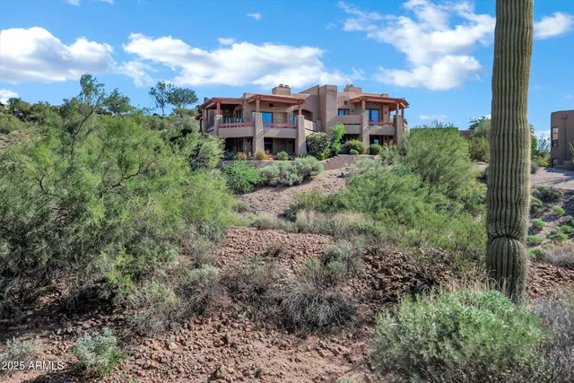 a view of a garden with a building in the background