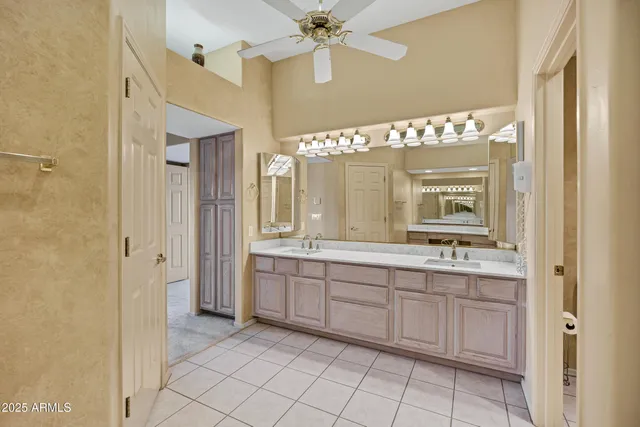 a bathroom with a double vanity sink and a mirror