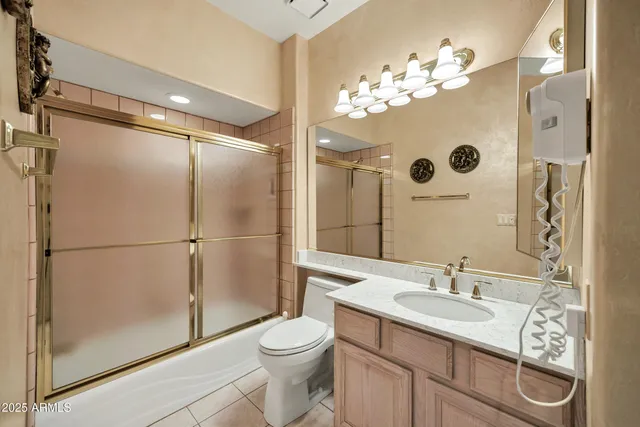 a bathroom with a sink toilet a mirror and shower