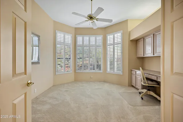 a view of livingroom with workspace and a window
