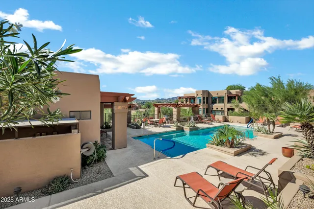a view of a house with a yard and sitting area
