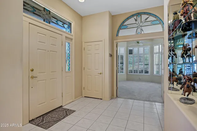 an empty room with fan and windows