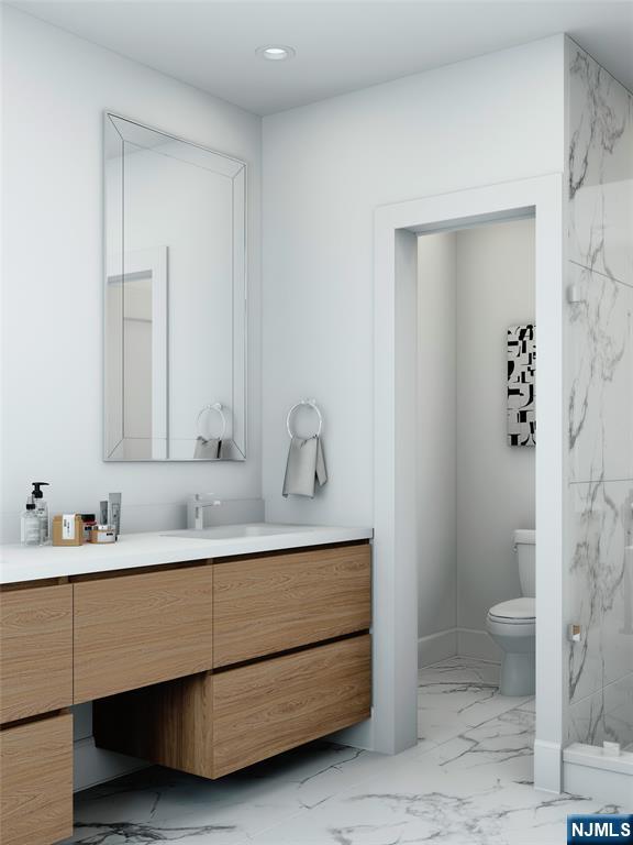 14 Feldman Court Paramus, NJ 07652 - Photo 17 of 24 a bathroom with a sink and a mirror