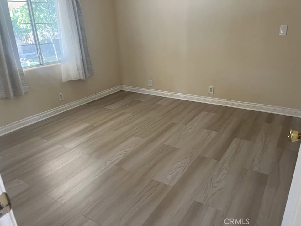 1320 3 Ranch Road Duarte, CA 91010 - Photo 15 of 16 an empty room with wooden floor and windows