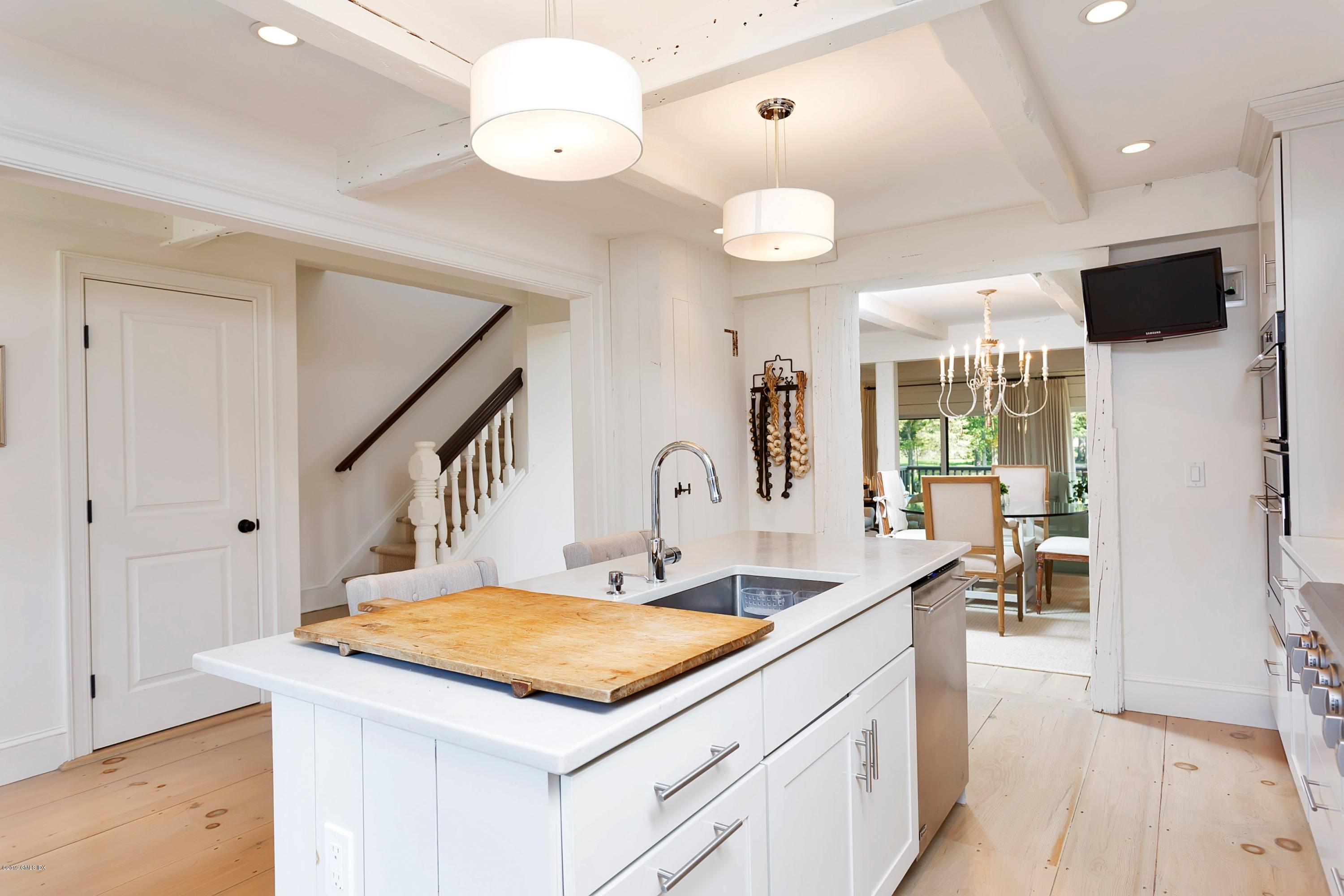 603 Steamboat Road, Unit 5 Greenwich, CT 06830 - Photo 16 of 26 a kitchen with stainless steel appliances granite countertop a sink a stove and a refrigerator