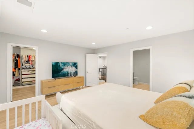 a bedroom with a bed and a flat screen tv