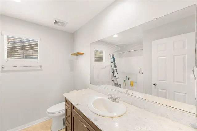 a bathroom with a sink toilet and vanity