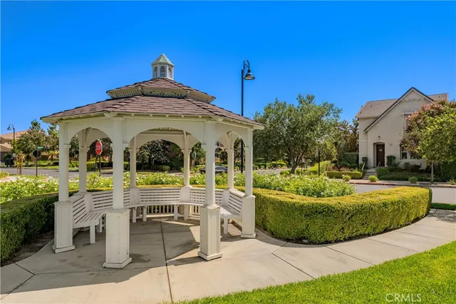 an aerial view of a house a yard and a fountain