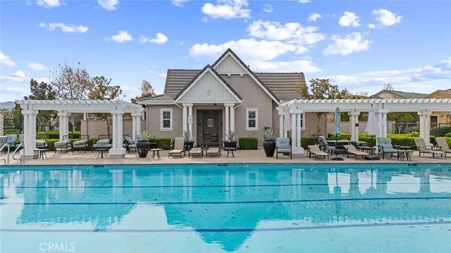 an aerial view of a house with a garden and lake view