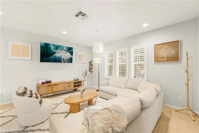 a bedroom with furniture and a flat screen tv