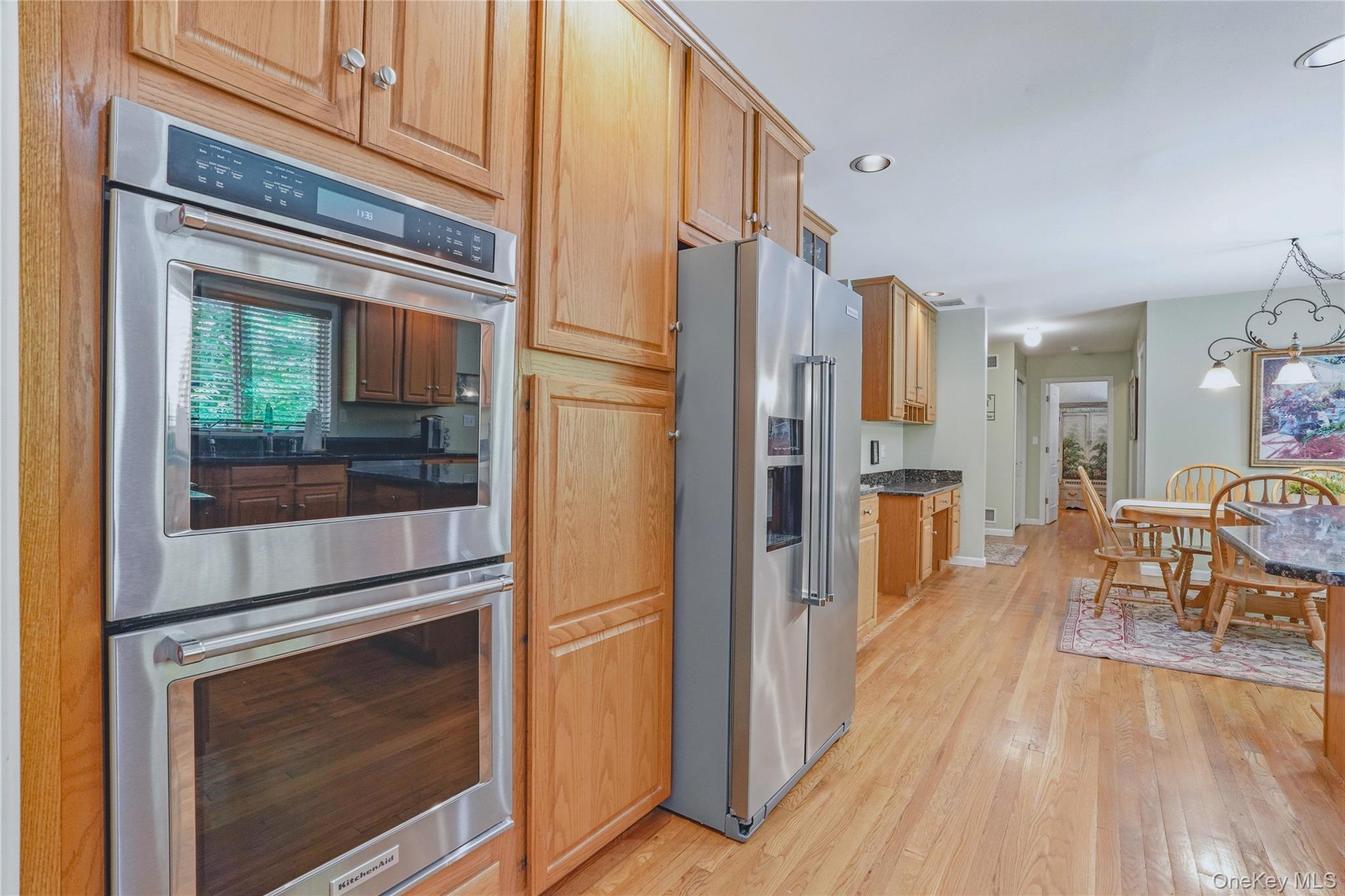 2 Windsor Lane Cornwall, NY 12518 - Photo 16 of 50 a kitchen view with a refrigerator a stove and a dining table with wooden floor