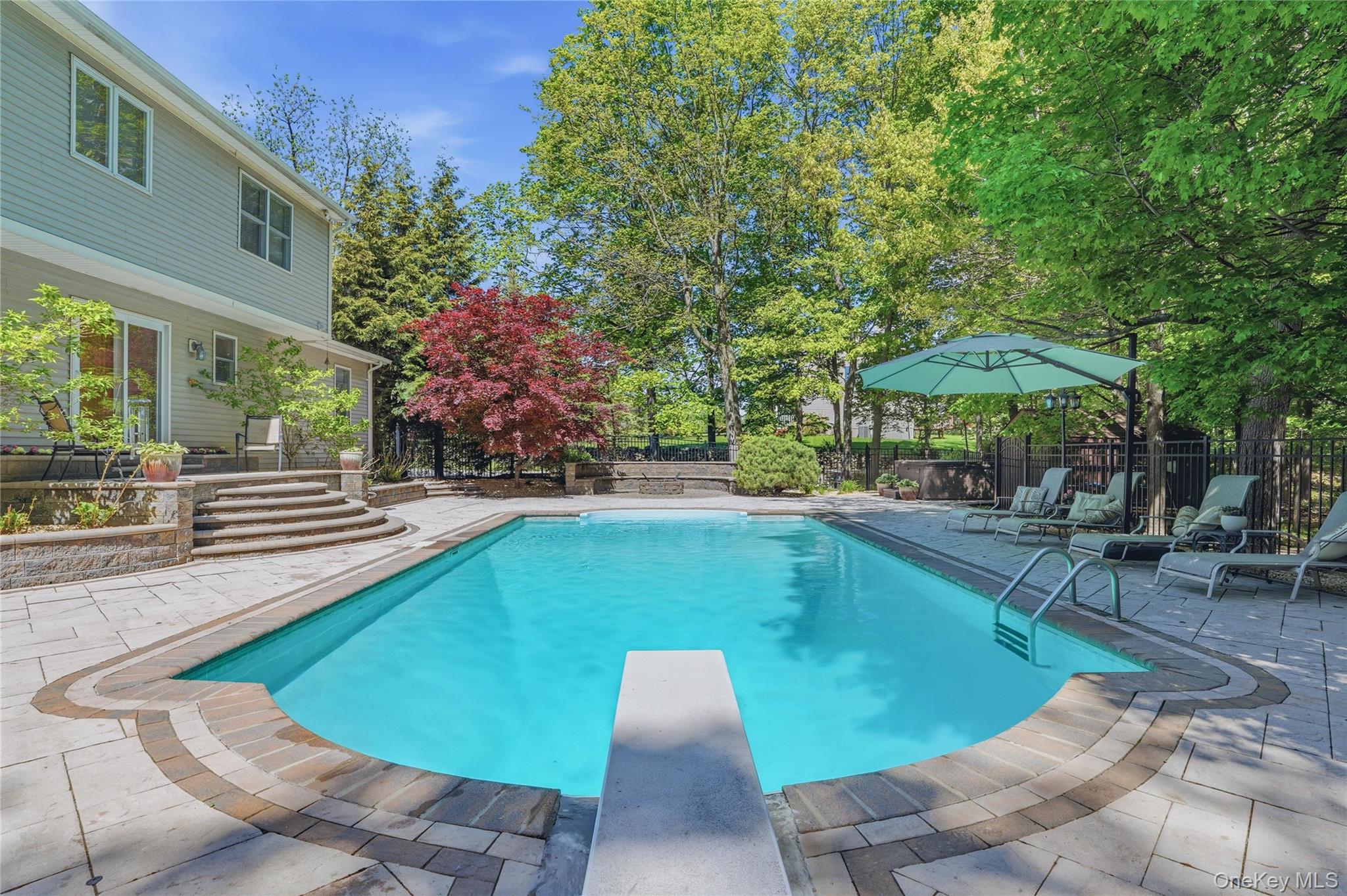 2 Windsor Lane Cornwall, NY 12518 - Photo 37 of 50 a view of a swimming pool with chairs and an umbrella