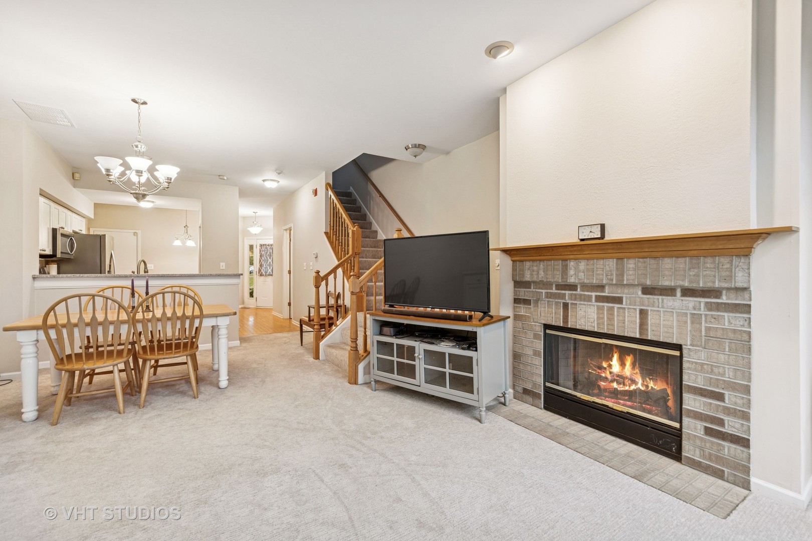 8291 Ripple Ridge, Unit 8291 Darien, IL 60561 - Photo 12 of 23 a living room with furniture a fireplace and a flat screen tv