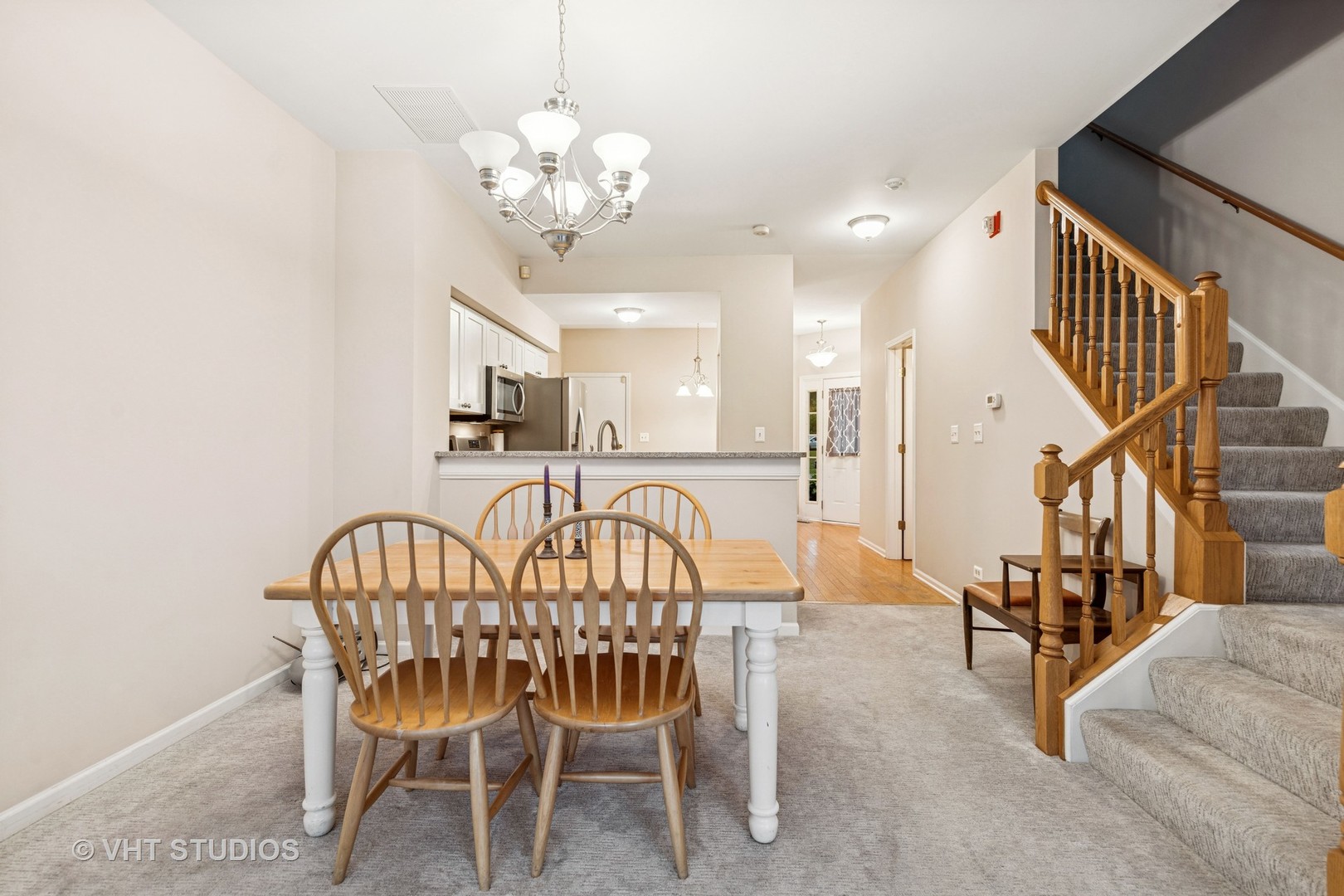 8291 Ripple Ridge, Unit 8291 Darien, IL 60561 - Photo 13 of 23 a view of a dining room with furniture and a chandelier
