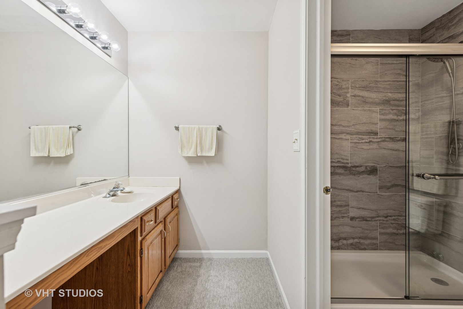8291 Ripple Ridge, Unit 8291 Darien, IL 60561 - Photo 17 of 23 a spacious bathroom with a shower sink and mirror
