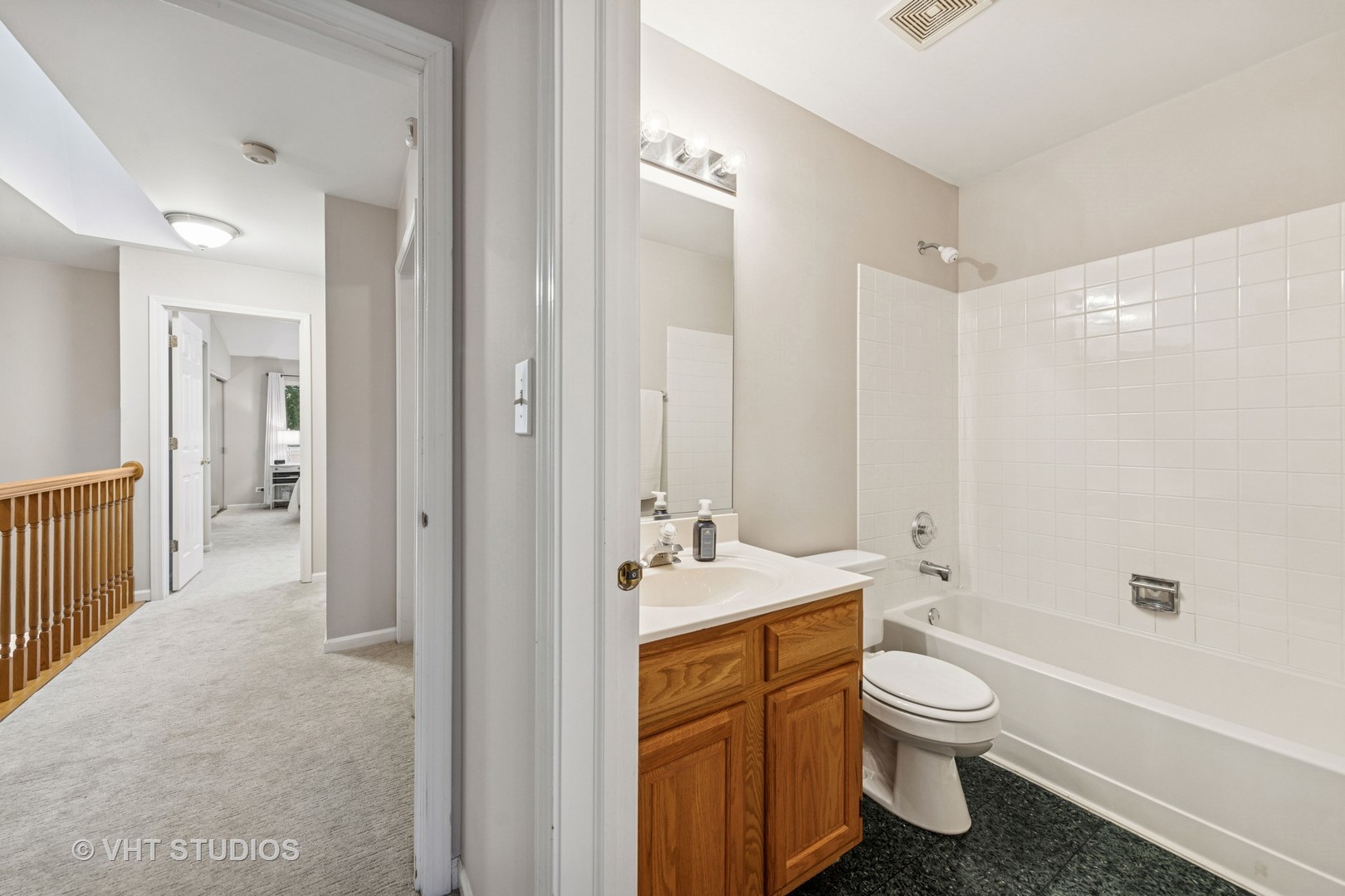 8291 Ripple Ridge, Unit 8291 Darien, IL 60561 - Photo 19 of 23 a bathroom with a bathtub sink vanity mirror and toilet