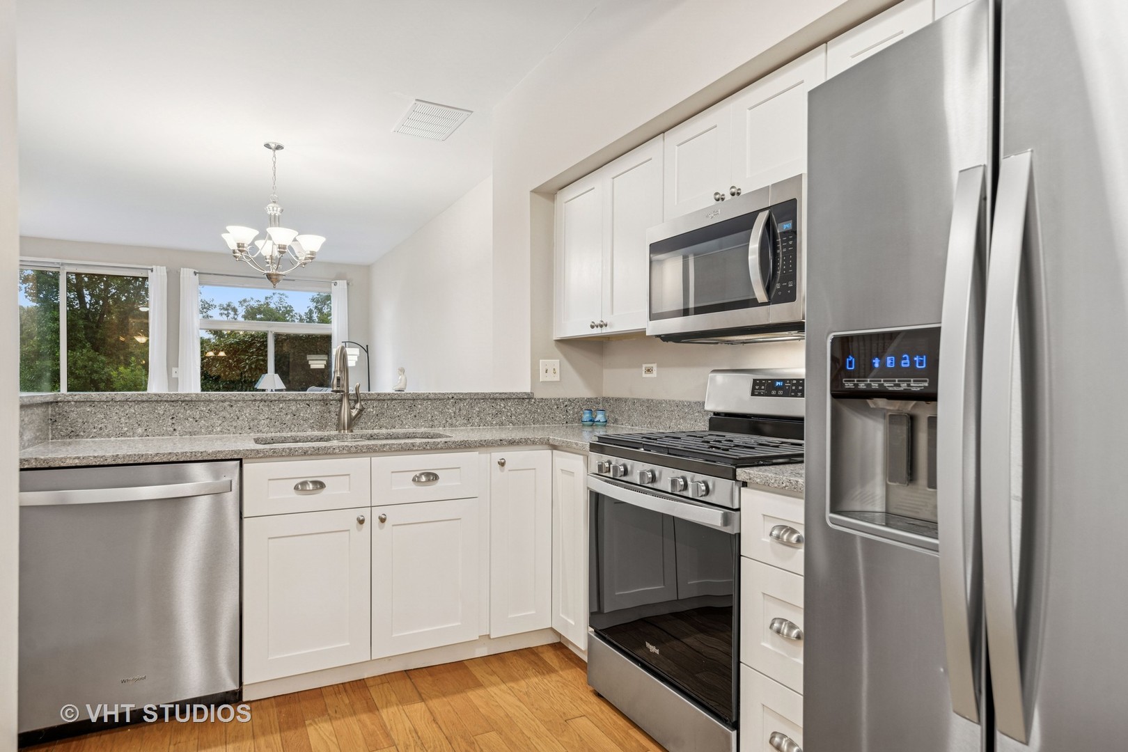 8291 Ripple Ridge, Unit 8291 Darien, IL 60561 - Photo 6 of 23 a kitchen with stainless steel appliances granite countertop a stove microwave and refrigerator