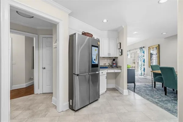 a kitchen with white cabinets and stainless steel appliances