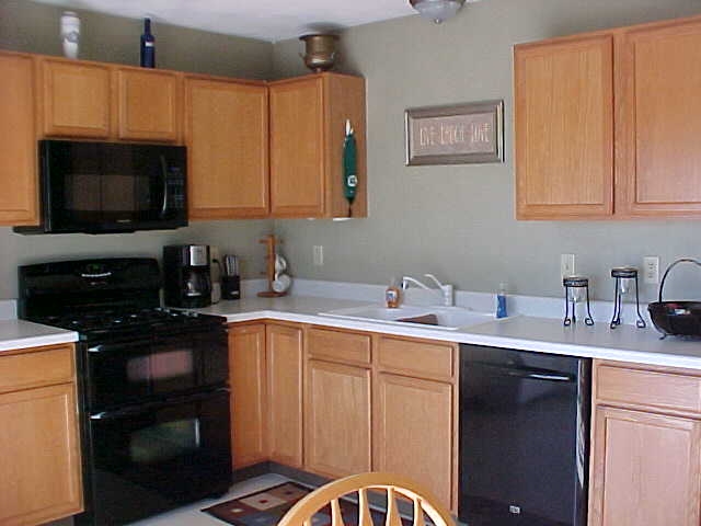 765 Bayfield Road Rockton, IL 61073 - Photo 7 of 18 a kitchen with stainless steel appliances granite countertop a sink stove and microwave