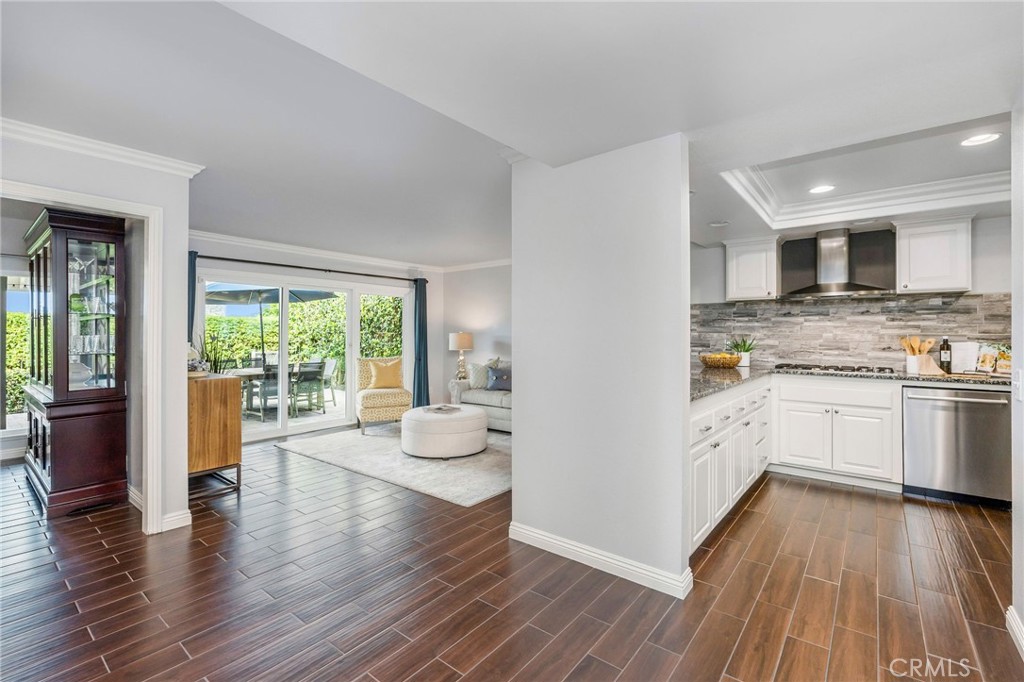 30392 North Hampton Road Laguna Niguel, CA 92677 - Photo 13 of 44 a kitchen with a white stove top oven and wooden floors