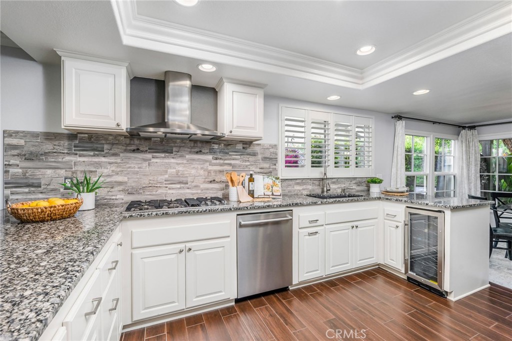 30392 North Hampton Road Laguna Niguel, CA 92677 - Photo 14 of 44 a kitchen with stainless steel appliances granite countertop a stove a sink and a white cabinets
