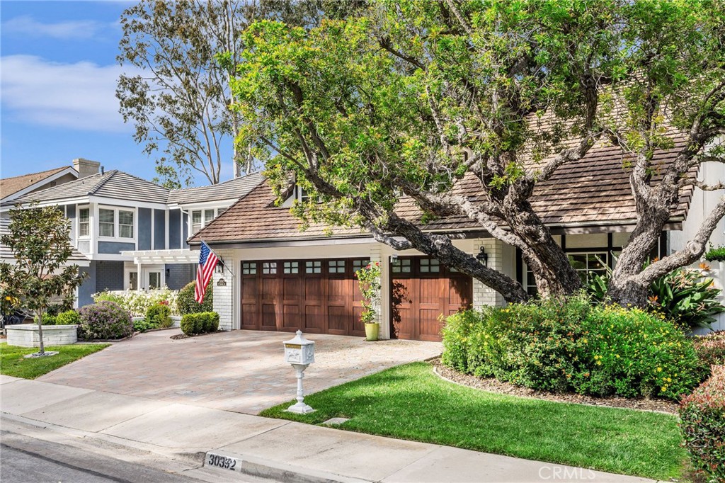 30392 North Hampton Road Laguna Niguel, CA 92677 - Photo 3 of 44 a front view of a house with a garden and plants