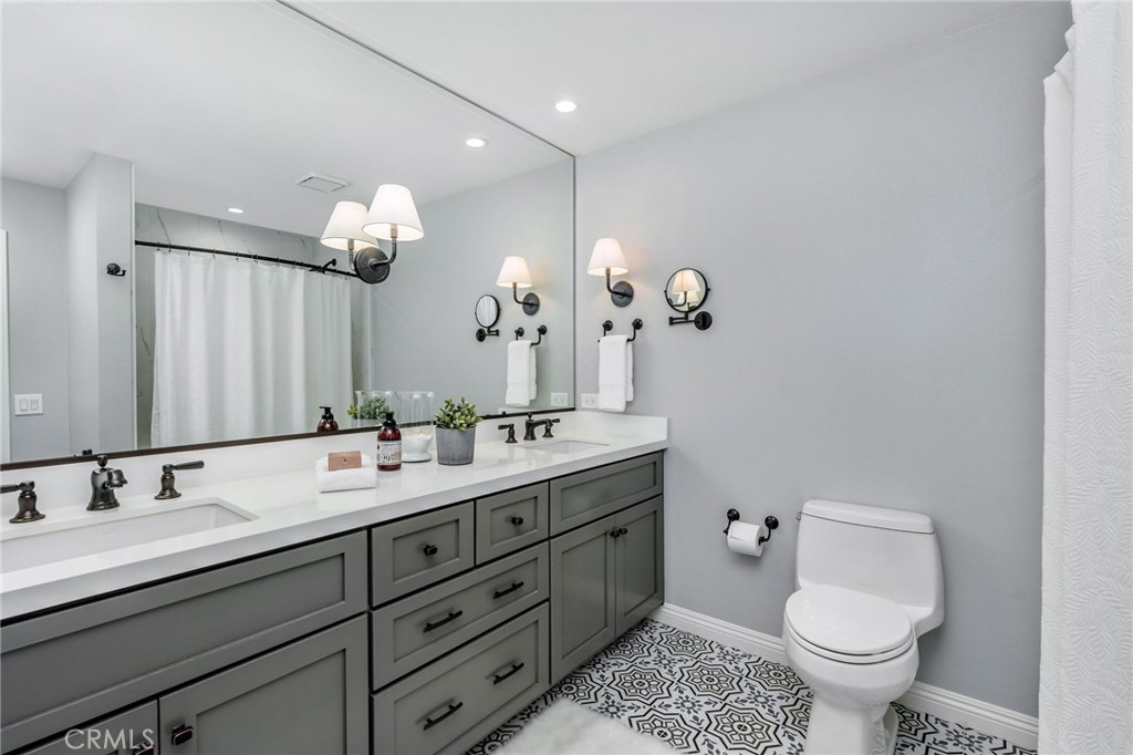 30392 North Hampton Road Laguna Niguel, CA 92677 - Photo 32 of 44 a bathroom with a toilet sink and mirror